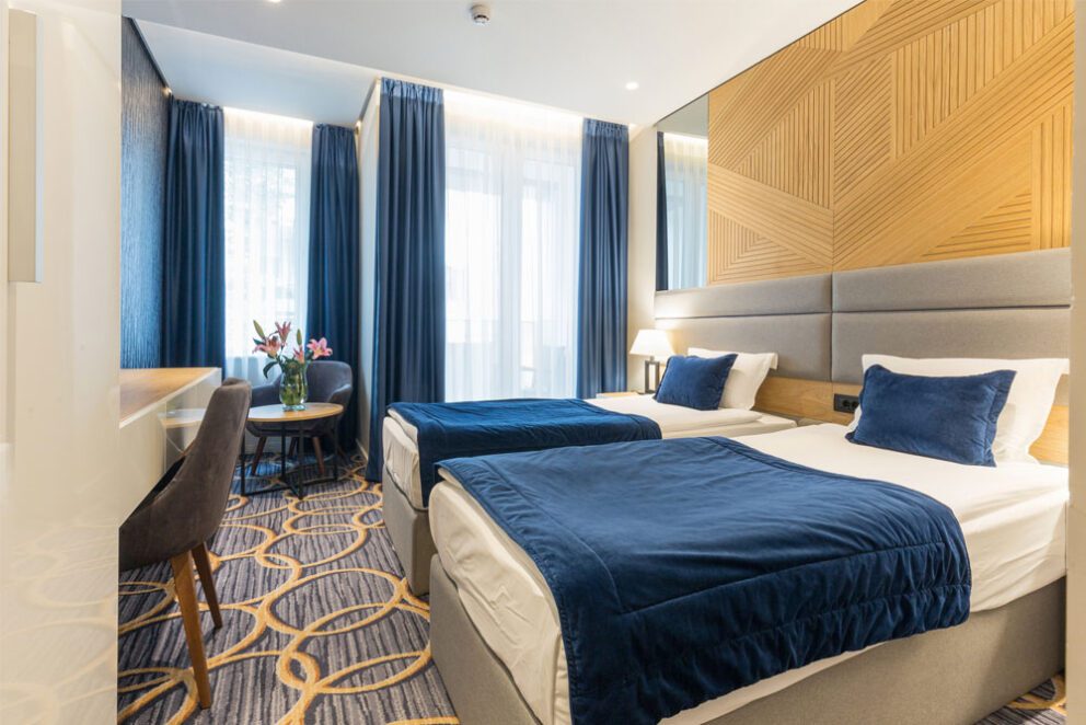The interior of a hotel room with two beds